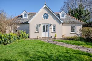 a white house with a green lawn at Cantre Selyf in Brecon