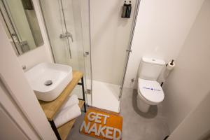 a bathroom with a toilet and a shower and a sink at Hostel Nixar in Almería +36 photos