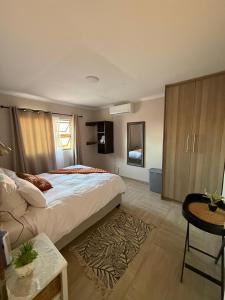 a bedroom with a large bed and a table at Seabreeze Accommodation in Lüderitz +56 photos