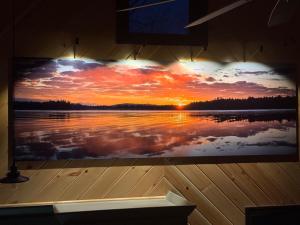 a painting of a sunset over a lake at The Old Orchard Cottage in LaFayette