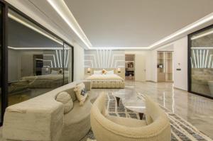 a large room with a bed and a couch and chairs at Villa Royale Marrakech in Marrakesh +46 photos