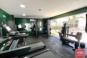 a gym with treadmills and machines in a room at Flat moderno Jade hotel in Brasília