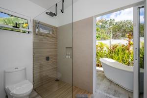 a bathroom with a tub and a toilet and a sink at Antemar Guest, Beach bungalow near Conchal in Brasilito +11 photos