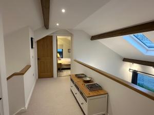 a room with a staircase and a room with a window at East Barn Bed & Breakfast in Wall +5 photos