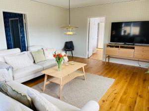 a living room with a white couch and a tv at 8 person holiday home in Moheda-By Traum in Moheda