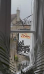 a sign that says the cleave on a window at The Cleave Inn in Lustleigh