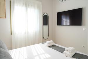 a room with a bed with two folded towels at Villa Selina 1 - Etheras Properties in Kythira