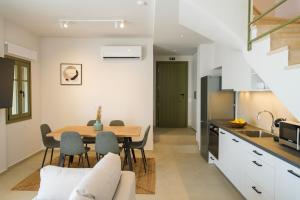 a kitchen and dining room with a table and chairs at Villa Selina 1 - Etheras Properties in Kythira