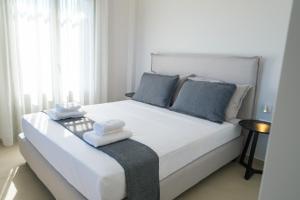 a bedroom with a large white bed with towels on it at Villa Selina 1 - Etheras Properties in Kythira +37 photos