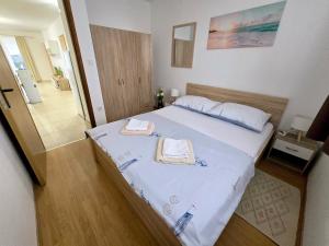 a bedroom with a large bed with two towels on it at Apartman Jadranka in Vir