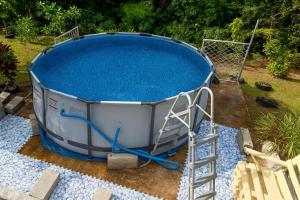 a large pool with blue water in it at Séjour Authentique et Paisible in Les Anses-dʼArlets