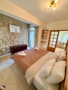 a bedroom with a large bed with towels on it at AGAPI Holiday House in Vouníon