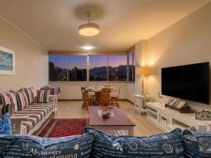a living room with a couch and a tv at Coastal Condo Strand in Strand