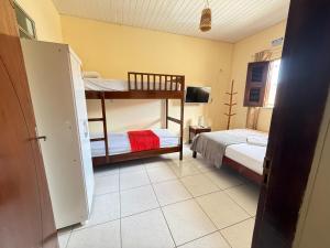 a bedroom with two bunk beds in a room at Pousada ExtraLar in Fortaleza