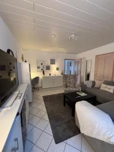 a living room with a couch and a table at Rheinauszeit in Rheinbrohl