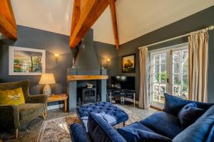 a living room with a blue couch and a fireplace at Cantre Selyf in Brecon