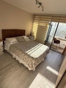 a bedroom with a large bed and a large window at Hermoso Depto Almarza in Rancagua +8 photos
