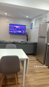 a living room with a white table and a couch at Cozy Urban Hideout in Saskatoon