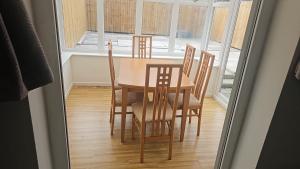 a table and chairs in a room with a window at Leasowe House in Bidston
