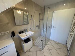 a bathroom with a shower and a sink and a toilet at Küstenbude Ostseestübchen in Grömitz +22 photos