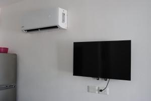a flat screen tv hanging on a wall at CASA JARDIN in Cancún