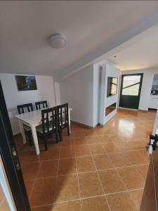 a kitchen and dining room with a table and chairs at Apartment 4 by Villa Ceni in Elbasan