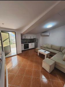 a living room with a couch and a table at Apartment 4 by Villa Ceni in Elbasan