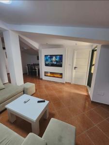 a living room with a couch and a table at Apartment 4 by Villa Ceni in Elbasan