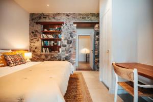a bedroom with a bed and a desk in it at La Petite Maison dans la mer in Saint-Pierre