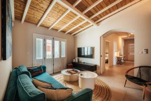 a living room with a couch and a table at La Petite Maison dans la mer in Saint-Pierre