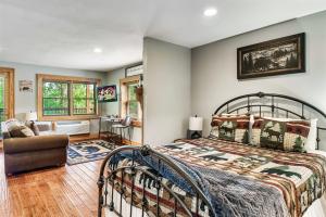 a bedroom with a bed and a chair in a room at 2mils Dollywood, Resort Pool, King Bed, SL6 in Pigeon Forge