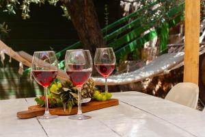 three glasses of red wine sitting on a table at Olympos Mocamp in Kaş +27 photos