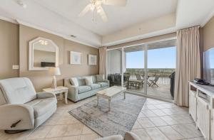 a living room with a couch and a table at Wharf 615 by Youngs Suncoast in Orange Beach +68 photos