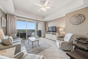 a living room with a couch and chairs and a table at Wharf 615 by Youngs Suncoast in Orange Beach