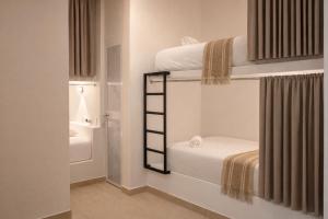 a room with two bunk beds with a ladder at Casa Helena Getsemaní in Cartagena de Indias
