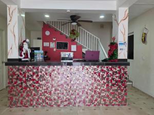 a restaurant with a red and white tile counter at Hotel Mexico in Cancún