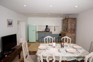 a dining room with a table with chairs and a television at Domaine de charme pour groupes et evenement in Chillac