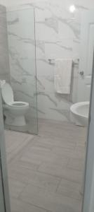 a white bathroom with a toilet and a sink at Apartamento-2B-Zona-Colonial in Santo Domingo +12 photos