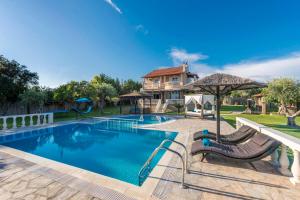 a swimming pool with a slide and a playground at Maxim in Corfu