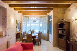 a dining room with a table and chairs and a window at Maxim in Corfu
