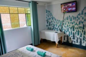 a room with two beds and a table and a window at TuKasa Boutique Liberdad - Buen cafe en Terraza Interior in Ayacucho +46 photos