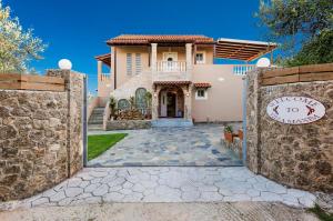 a house with a gate in front of it at Maxim in Corfu