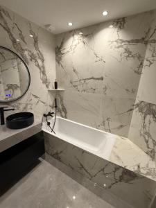 a bathroom with a white tub and a mirror at Maison moderne in Saint-Julien-de-Concelles +12 photos