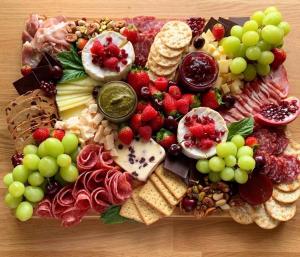 a plate of food with fruit and cheese and crackers at Falusi ház Tóth György in Bajša +19 photos