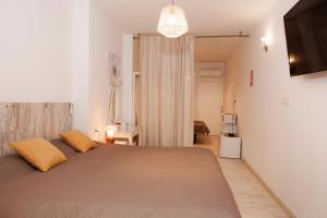 a bedroom with a large bed with yellow pillows at Loft Valentia Ifach Calpe in Calpe +7 photos