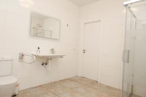 a white bathroom with a sink and a toilet at Loft Valentia Ifach Calpe in Calpe