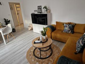 a living room with a couch and a table at PIK-Kwatery in Morąg