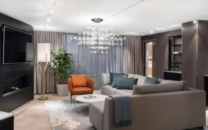 a living room with a couch and a chandelier at Radisson Blu Royal Hotel, Helsinki in Helsinki +70 photos