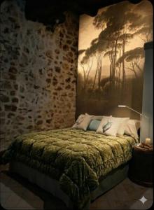 a bedroom with a bed with a painting on the wall at La chiave del Tempo in Casteldilago +41 photos