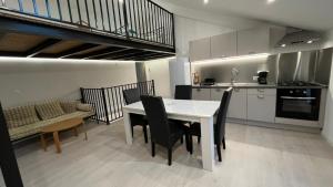 a kitchen and dining room with a table and chairs at Le loft sous les toits in Arles